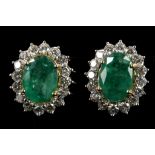 A pair of 18ct gold, emerald and diamond set clust