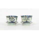 A pair of Chinese doucai rice bowls and stands, Kangxi marks but 19th Century, the interiors