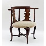 A George I elm desk chair with bowed top rail and vase shaped splats, the stuff-over seat on