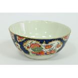 A Worcester slop bowl, circa 1770, painted in the Kakiemon style with cartouches of flowers, foliage