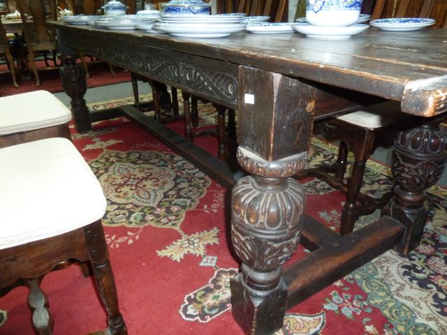 An Elizabethan style oak refectory table, the three-plank top on leaf carved rails and bulbous - Image 5 of 8