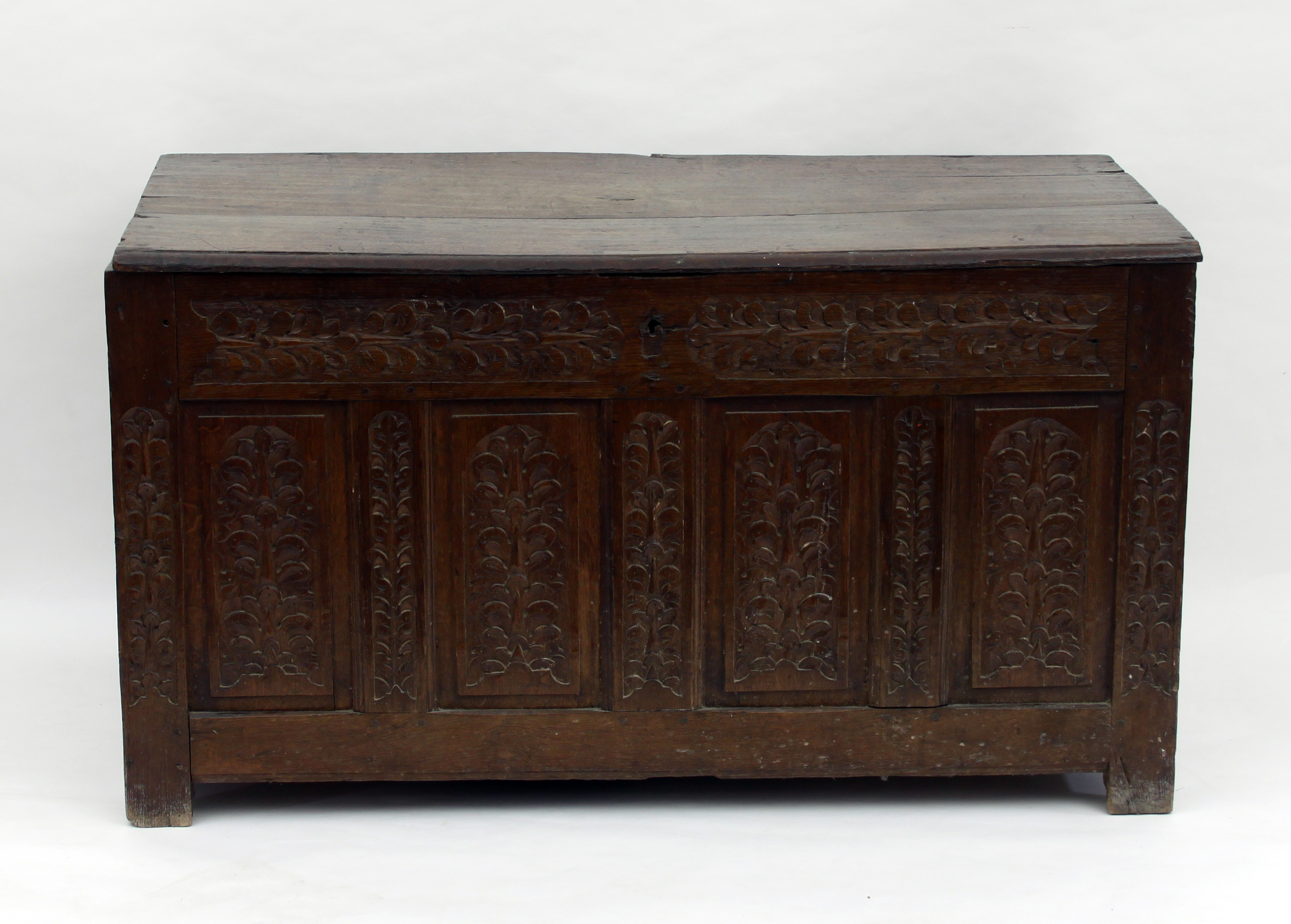 An oak chest with carved four-panel fron