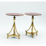 A pair of painted gilt wood circular top