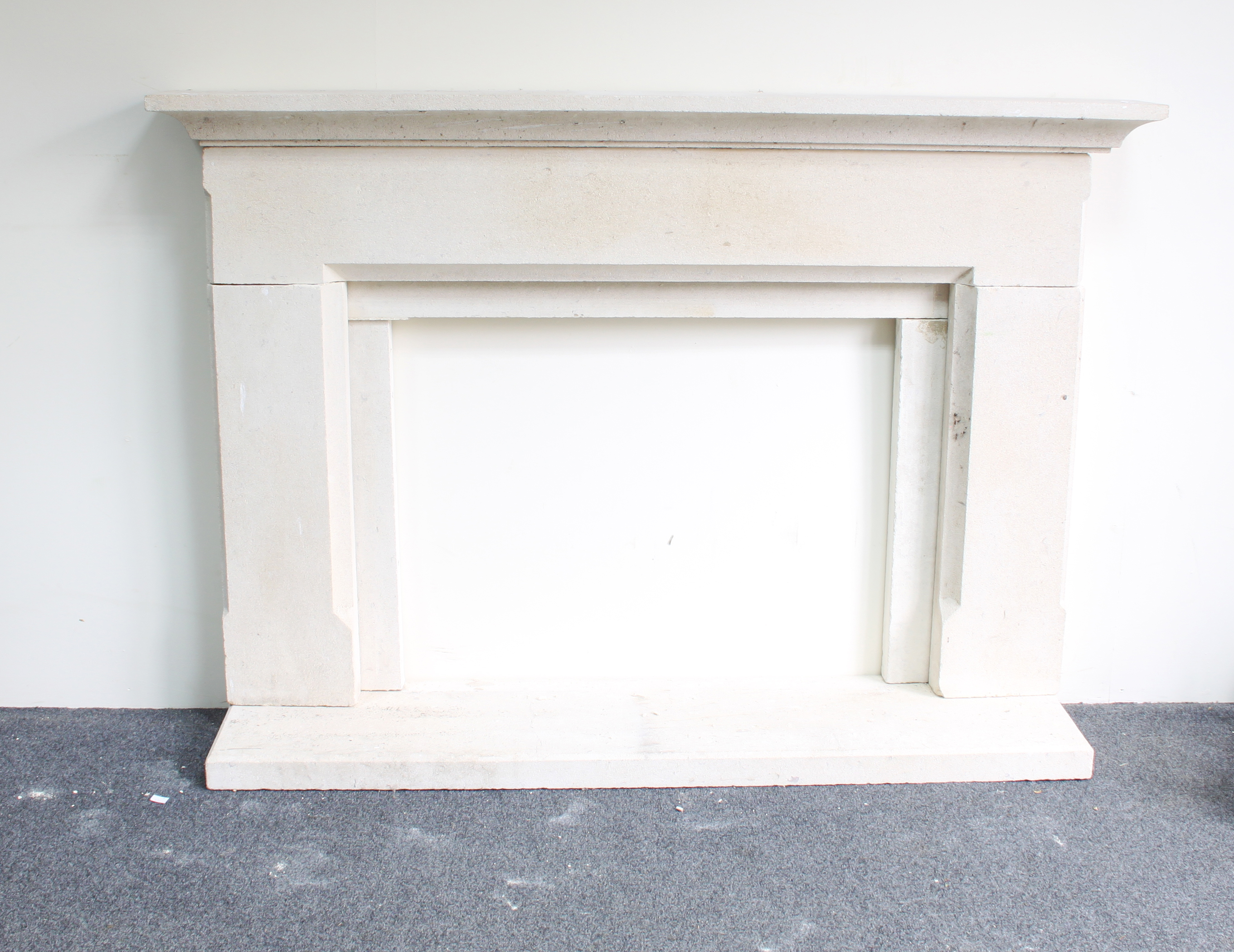 A limestone fire surround, 99cm x 145cm