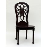 A George II hall chair, the pierced back