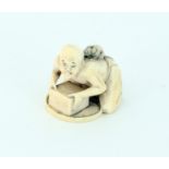 A Japanese ivory okimono of a rat catche