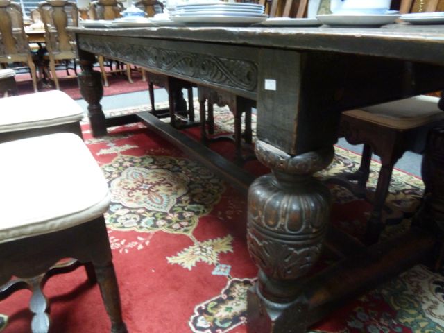 An Elizabethan style oak refectory table, the three-plank top on leaf carved rails and bulbous - Image 4 of 8