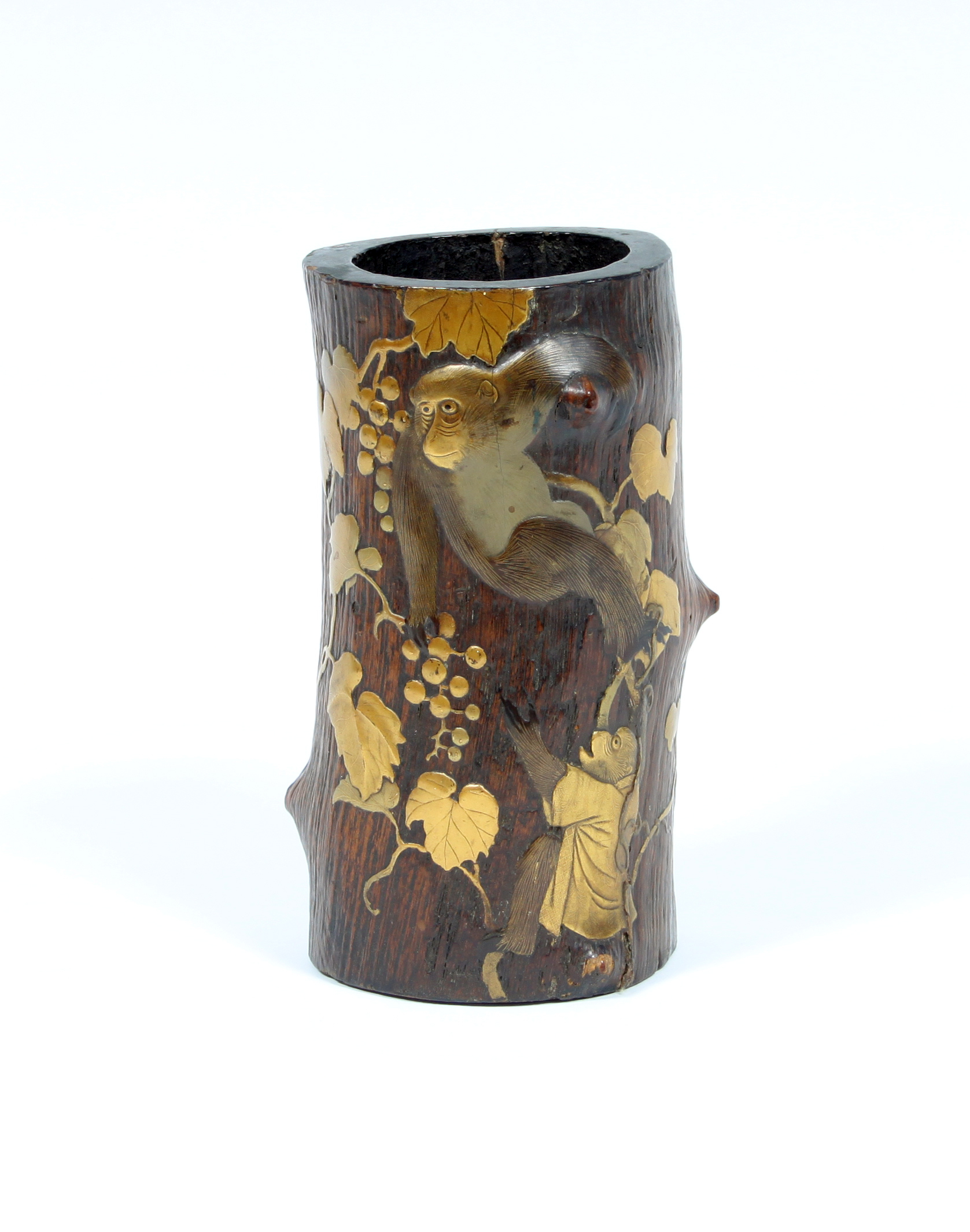 A Japanese carved bamboo vase, Meiji period, highlighted in gilt depicting monkeys climbing a