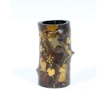 A Japanese carved bamboo vase, Meiji period, highlighted in gilt depicting monkeys climbing a