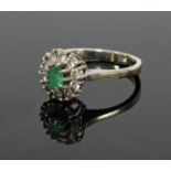 A gold, emerald and diamond cluster ring
