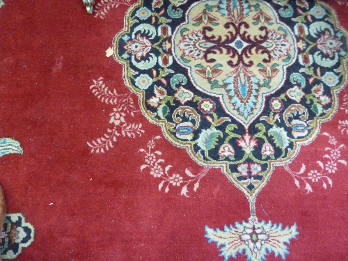 An Oriental style carpet, the central me