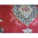 An Oriental style carpet, the central me