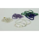 A collection of bead necklaces including