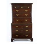 A George III mahogany chest on chest, with three short and three long drawers above a brushing slide