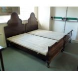 A pair of mahogany single beds, the arch