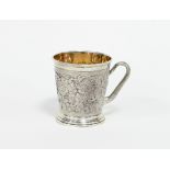 A silver Christening mug, 1871, chased with vine and with initialled plaque, 9cm high, approximately