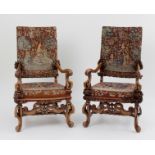 A pair of walnut upholstered armchairs o