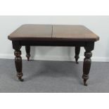 An Edwardian mahogany extending dining t