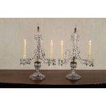 A pair of Irish cut glass two-branch candelabra, with lustre fittings and central obelisk on a cut