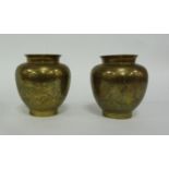 A pair of Tibetan engraved brass vases,