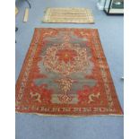 An Afghan rug, central medallion on a purple ground with guard stripes, 137cm wide and a Persian