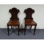 A pair of Victorian mahogany hall chairs Condition Report: The Hall chairs are in sound condition