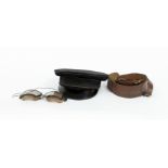 A pair of early 20th Century aviation goggles, a Sam Browne belt and an Italian officer's peaked hat