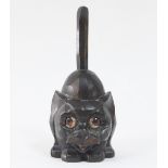 An Oswald type 'rolling eye' clock, the carved case modelled as a cat, the eyes telling the