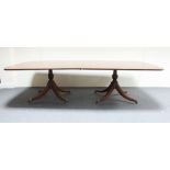 A George III style mahogany pedestal dining table, the top with crossbanding and boxwood stringing,