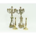 A pair of late Victorian brass five-light candelabra with foliate decoration to the scroll branches