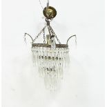 A three-tier hanging glass light fitting, hung with prismatic drops and another light fitting