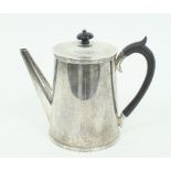 A silver coffee pot, C B London (date letter worn) with straight spout and ebonised handle and an