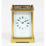 A gilt brass hour-repeat carriage clock, the white enamel dial with Roman numerals, retailed by Drew