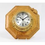 A Mouseman wall clock, the octagonal board with mouse to the moulded edge, mounted a brass cased