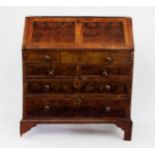 A George I walnut and feather-banded bureau, the fall revealing a fitted interior with a well,