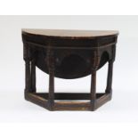 A Charles II style oak credence table, part 17th Century, the semi-circular top with a rear hinged