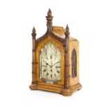 A Victorian gothic oak cased eight-day quarter-chiming mantel clock, the arch case with fluted