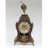 A boulle work mantel clock, surmounted by a figure of a winged angel, the dial with blue enamel