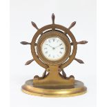 A late Victorian gilt brass mantel clock, modelled as a ship's wheel, fitted a white enamel dial