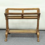 A 20th Century magazine rack on turned supports and cabriole legs, 71cm wide