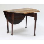 A George III mahogany oval drop-leaf table, on tapering legs and pad feet, 134.75cm wide