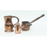 A George III copper jug 18cm high, a copper brandy saucepan and a copper pot and cover