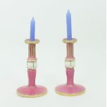 A pair of Bloor Derby candlesticks, with fluted knopped columns in pink and white and acanthus