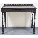 An Edwardian Chippendale style serpentine dressing table with pierced gallery above a blind fret