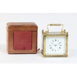 A gilt brass cased carriage clock, the white enamel dial with Roman numerals in a rectangular case