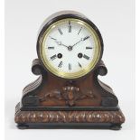 A 19th Century oak cased eight-day mantel clock with circular white enamel dial, the drum shaped