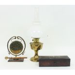 A brass oil lamp with opaque glass shade and chimney, a brass gong and an inlaid trinket box