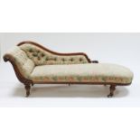 A Victorian walnut and button upholstered scroll end chaise longue, on turned legs with ceramic