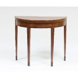 A George III mahogany semi-circular card table with cross-banded top,