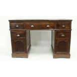 A walnut pedestal writing desk, with three frieze drawers upon pedestals,
